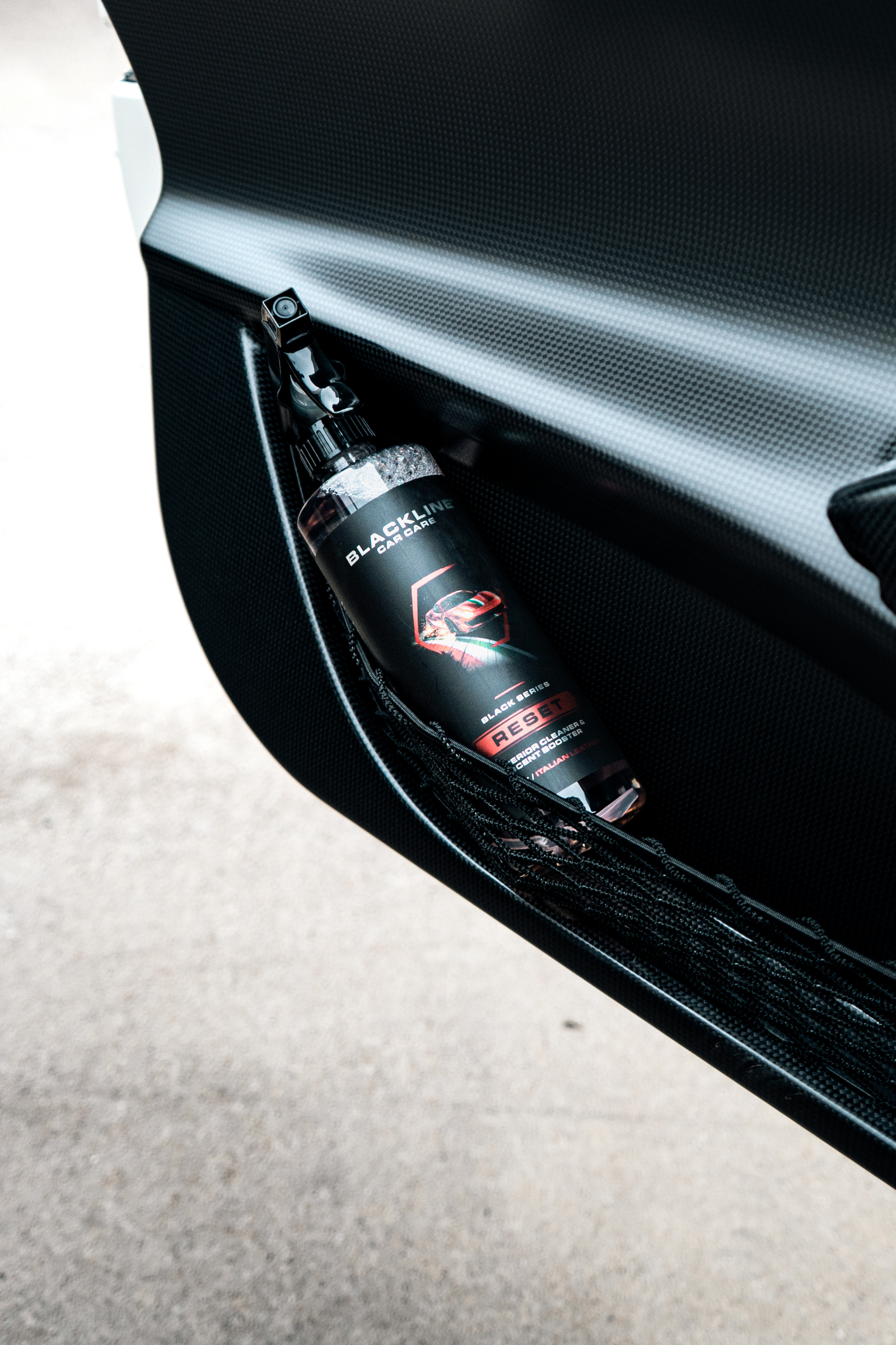 Blackline car care product being applied to a car door panel.